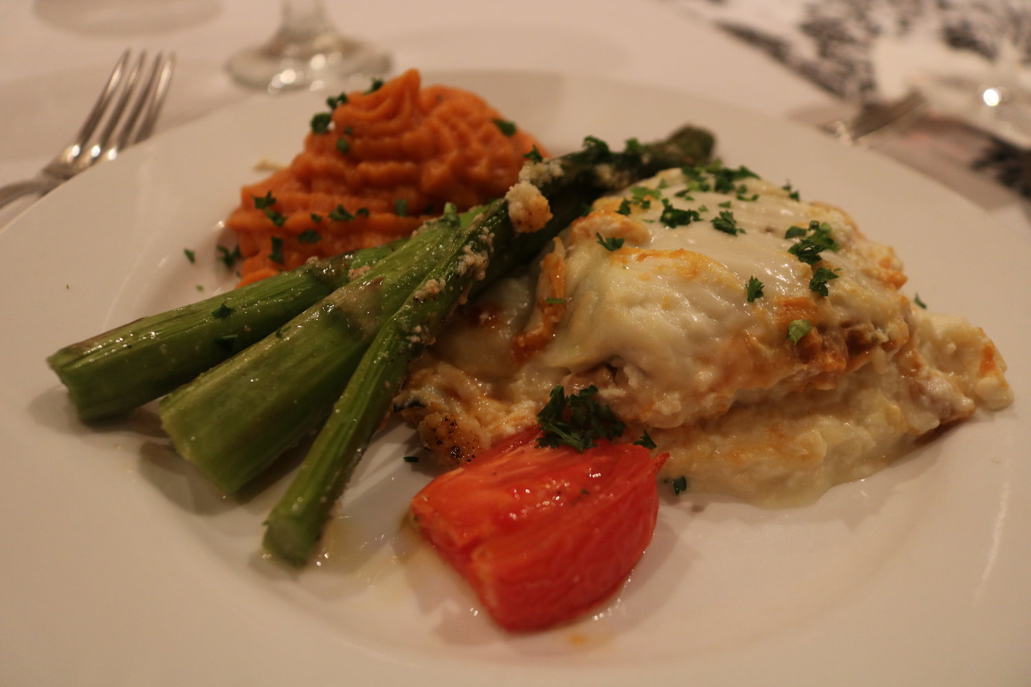 8.	A Fall-inspired pumpkin lasagna was served to guests, with a side of carrot, sweet-potato mash and roasted tomato halves.